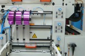 Foil feeds running transversely to sheet travel direction